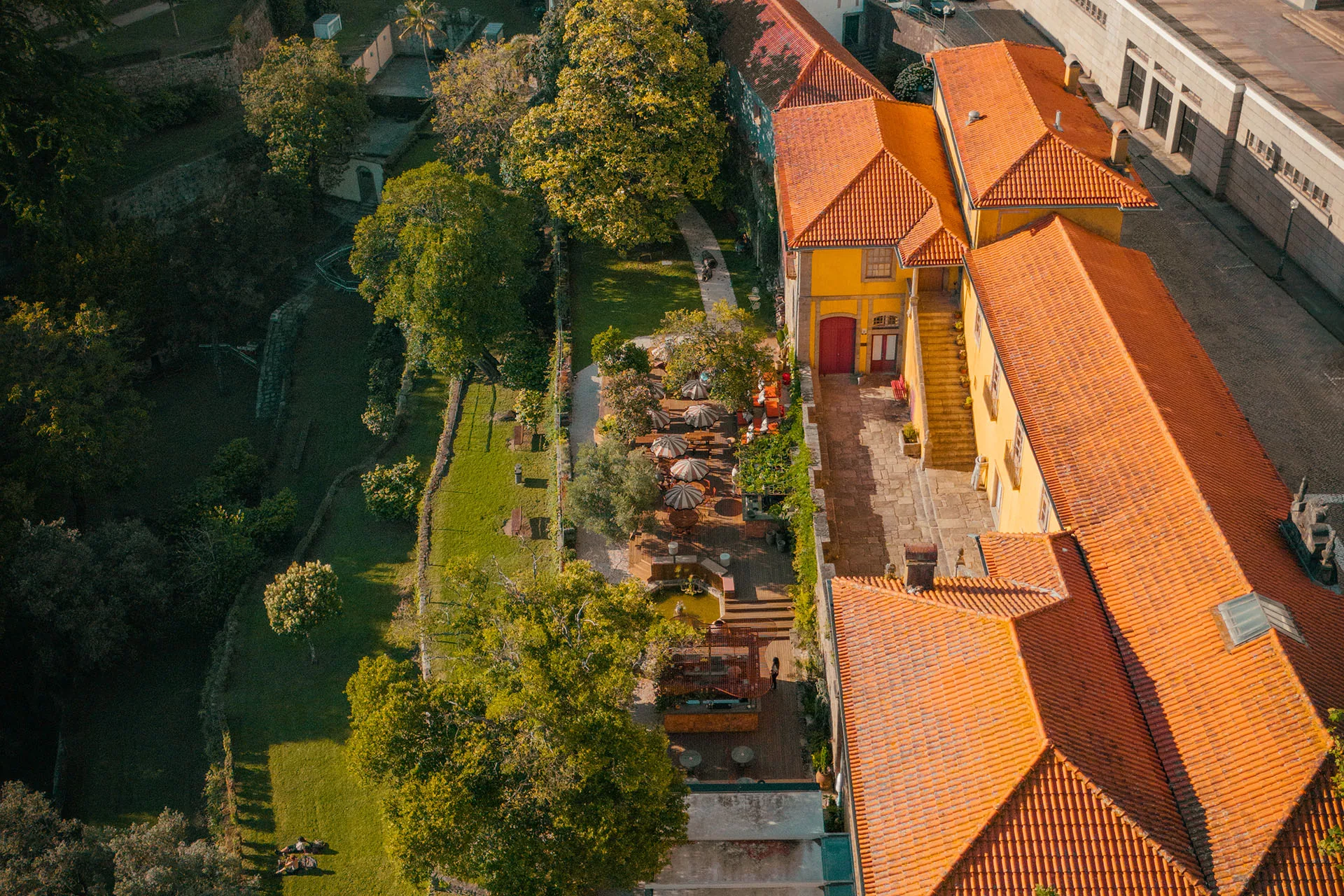 Aerial view of BOSCO Porto's garden terrace beside historic buildings