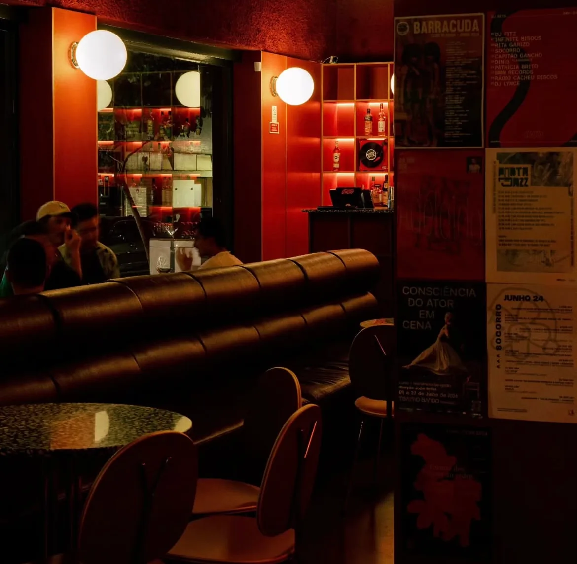 Red-lit interior of Fiasco bar in Bonfim with vinyl records and leather seating