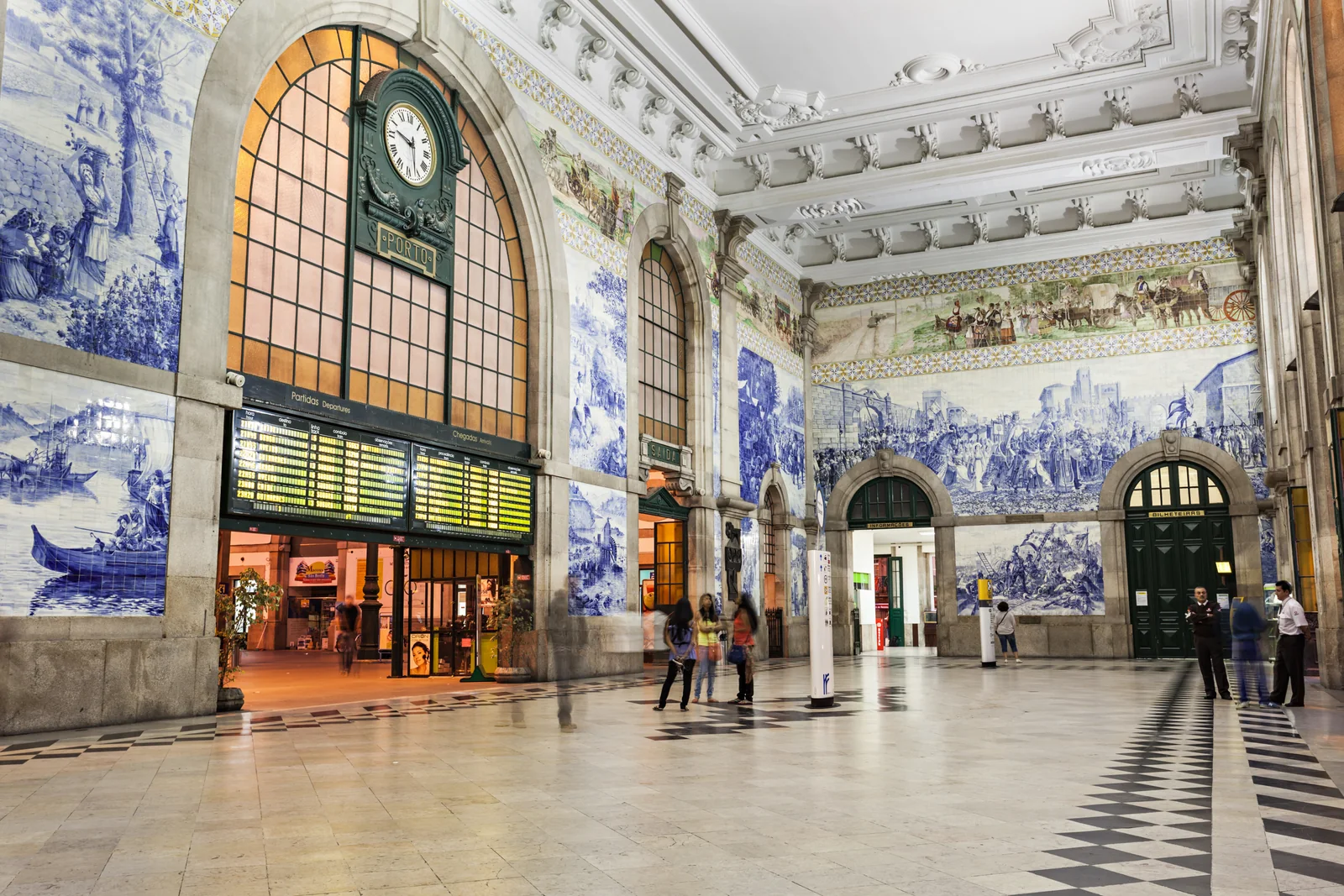The azulejo-covered entrance hall and clock inside São Bento Station in Porto