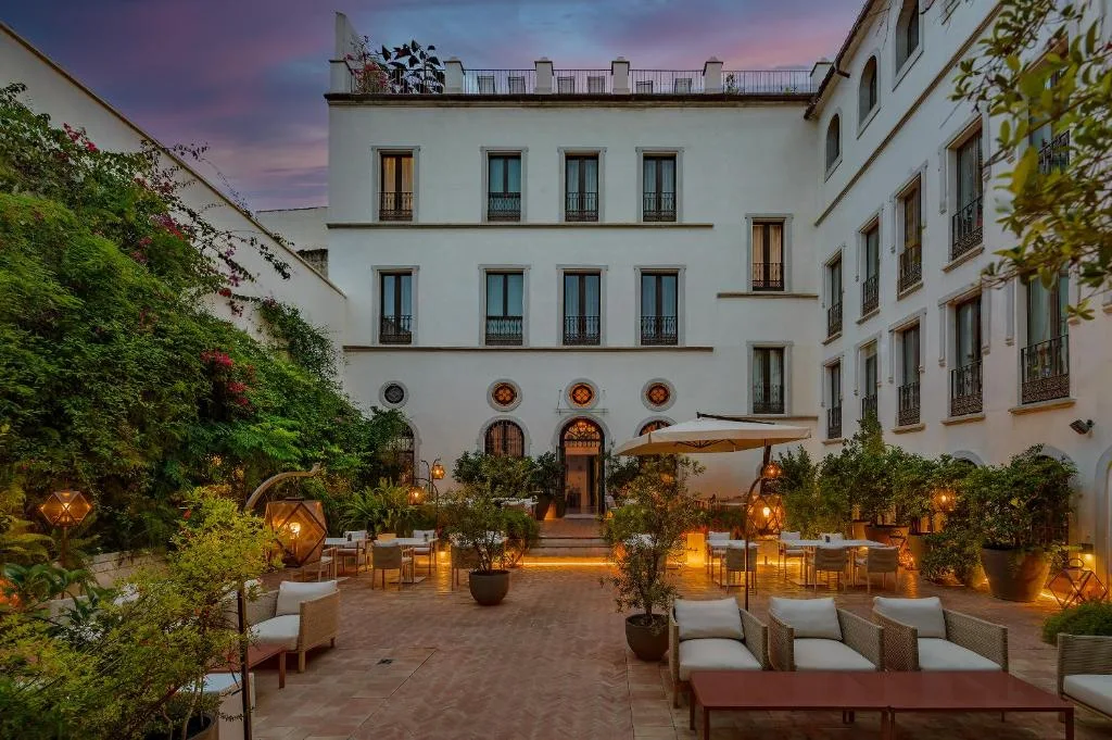 CoolRooms Palacio Villapanés Seville courtyard at dusk