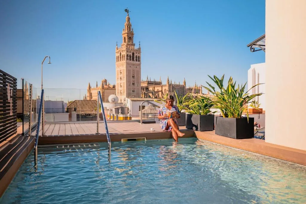 Joya del Casco by Shiadu rooftop pool with the Giralda in view